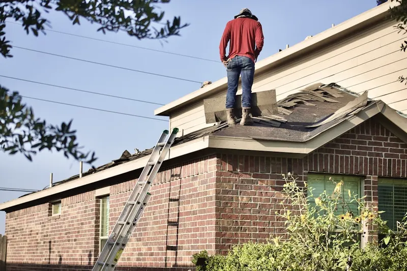 Professional roofer working on a residential roof in Rock Creek Estates